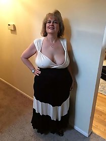 Experienced dame is taking off her underwear