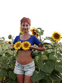 Aged girlfriend is posing undressed on the street